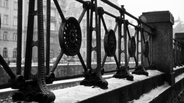 A black and white photography of a fence
