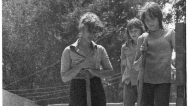 Women standing on sand with tools, Soviet Union, 1989