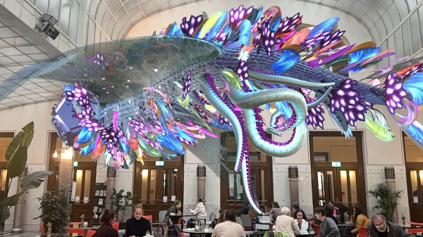 A colourful
                                          sculpture in front of an image of the cashier hall